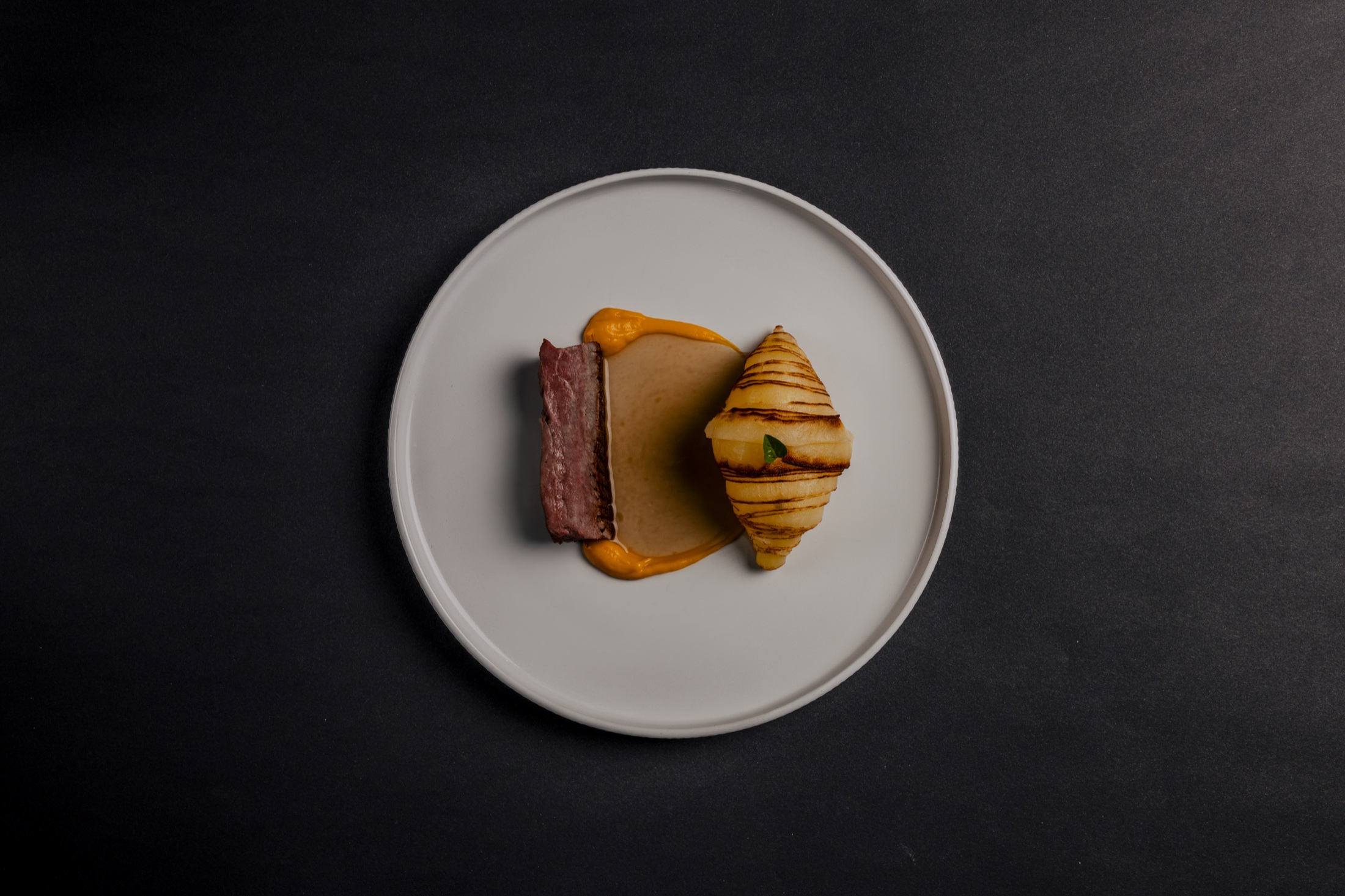 Fine-Dining-Gericht mit Lamm, Kartoffel und Sauce